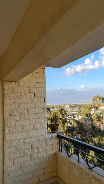a balcony with a view of a city at Pyramids Heritage suites in Ghaţāţī