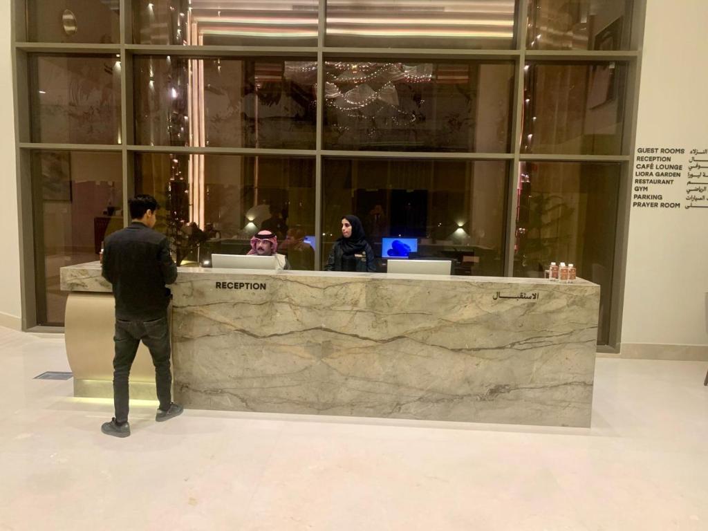 a man standing in front of a counter in a building at فندق ليورا Liora Hotel in Riyadh