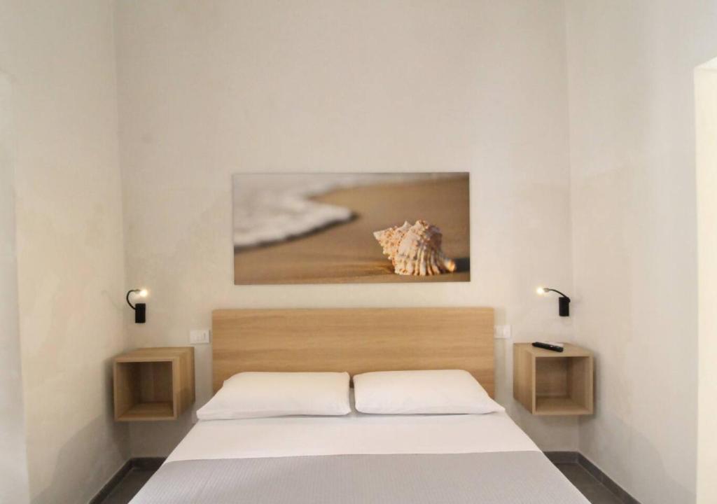 Postel nebo postele na pokoji v ubytování Mariù Loft & Apartments