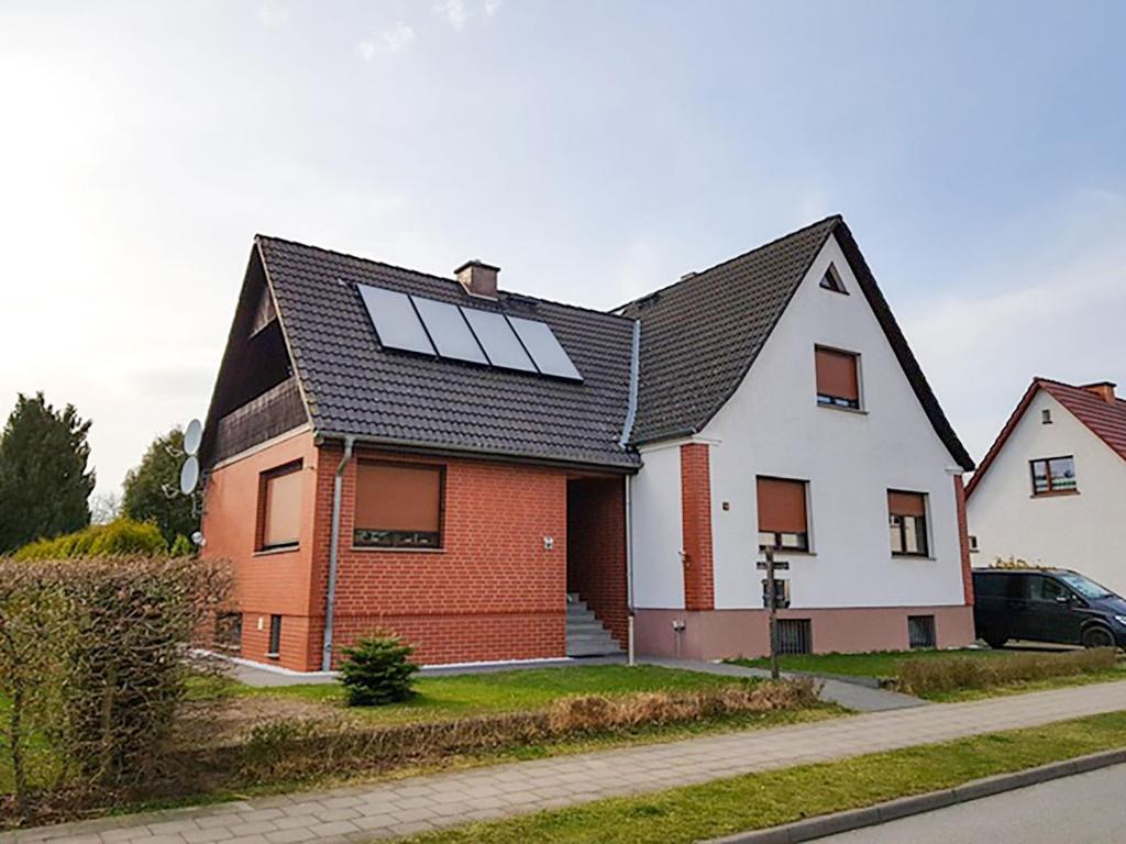 a house with solar panels on the roof at Ferienwohnung Ackermann in Ribnitz-Damgarten