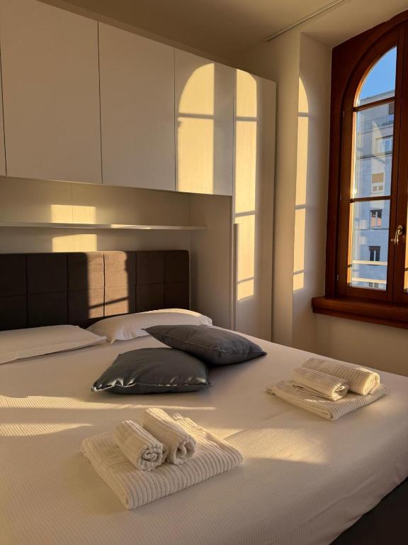 a bed with two towels sitting on top of it at Pep's Rooms by the sea in Trieste