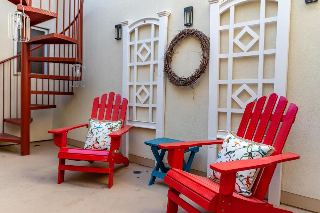 two red chairs with pillows sitting next to a staircase at Moonspinnerz in Paso Robles