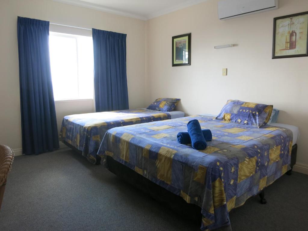Postel nebo postele na pokoji v ubytování VQ3 Lodge