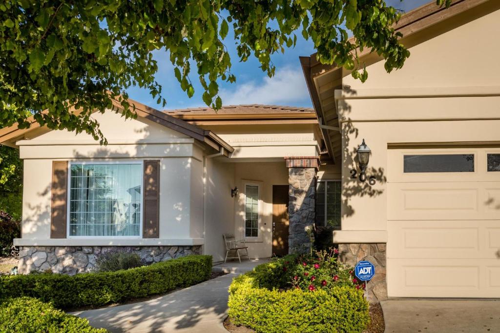 a white house with a garage at Ritz Del Rio in Paso Robles