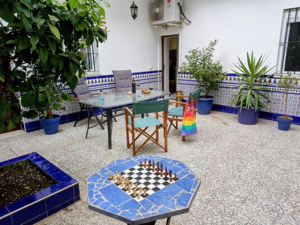 a patio with a table and a chess board and chairs at Casa Valientes B - Free private parking, patio, WiFi & AC in Jerez de la Frontera
