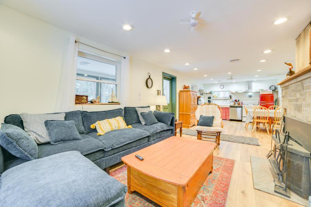 a living room with a couch and a table at 9 Mi to Snowmobile Trails! Home Near Mullett Lake in Cheboygan