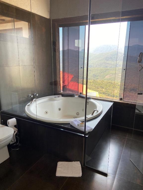 a bath tub in a bathroom with a window at Refúgio de Lavras in Ouro Preto