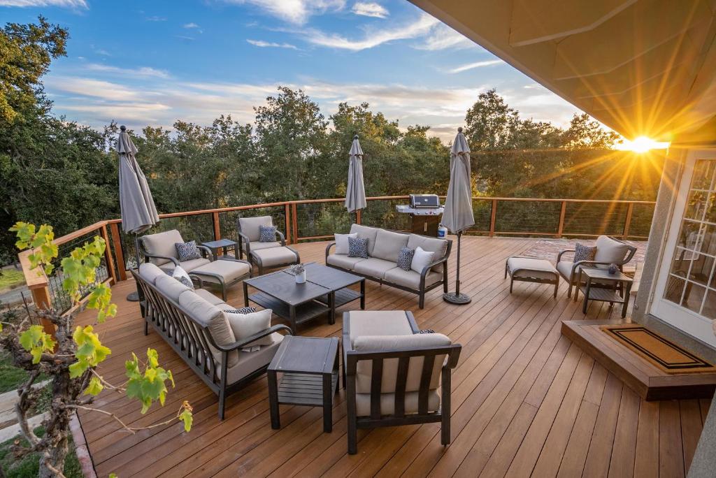 a deck with chairs and tables and umbrellas at G2N - G2 North Vineyard in Paso Robles