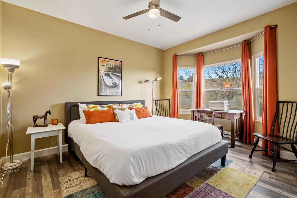 a bedroom with a large bed with orange pillows at Vista Mellow Cottage in San Miguel