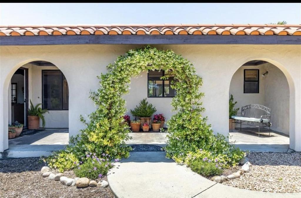 a house with an arched doorway with ivy at Hacienda Buena Vida in Templeton