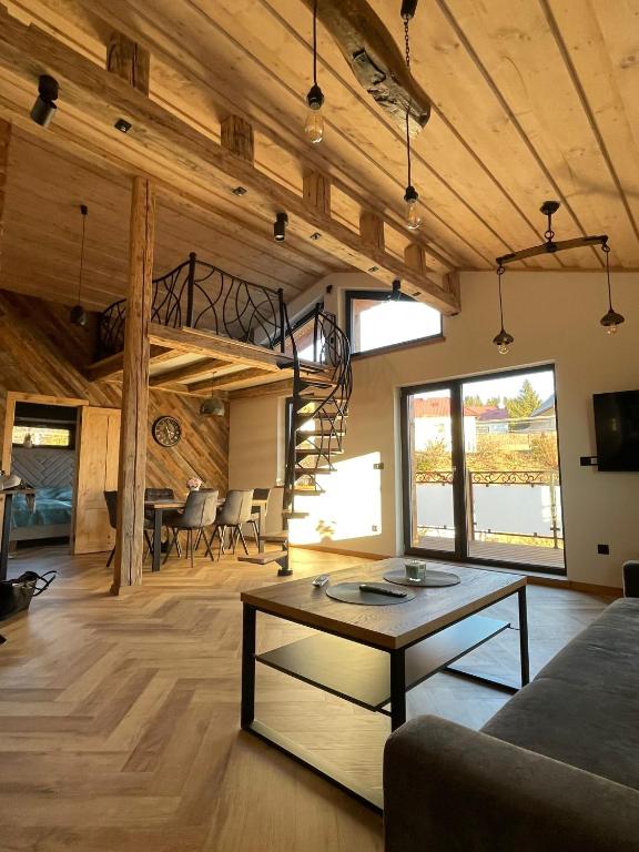 a living room with a couch and a table at Luxusny apartman z tarasmi - Vera in Telgárt