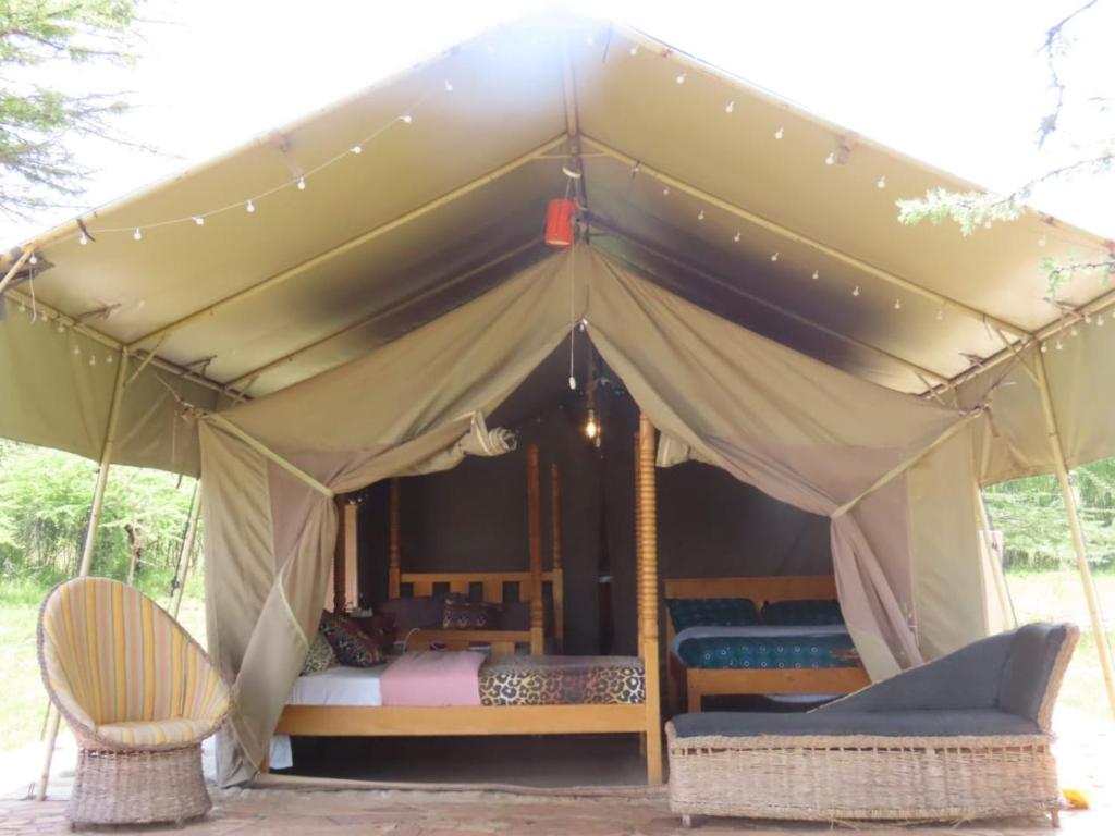 Postel nebo postele na pokoji v ubytování Giraff maasai mara home stay&safaris