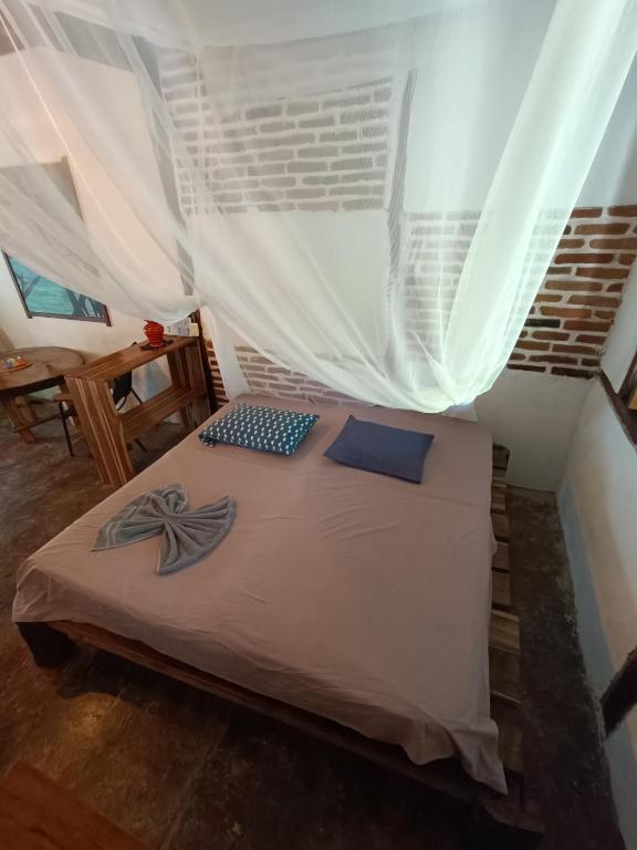 Postel nebo postele na pokoji v ubytování El Paraiso de Carmen