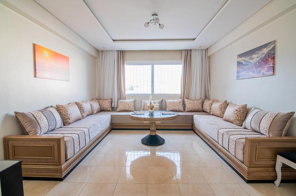a living room with a couch and a table at Steps from Top Attractions Apartement in Agadir Center in Agadir