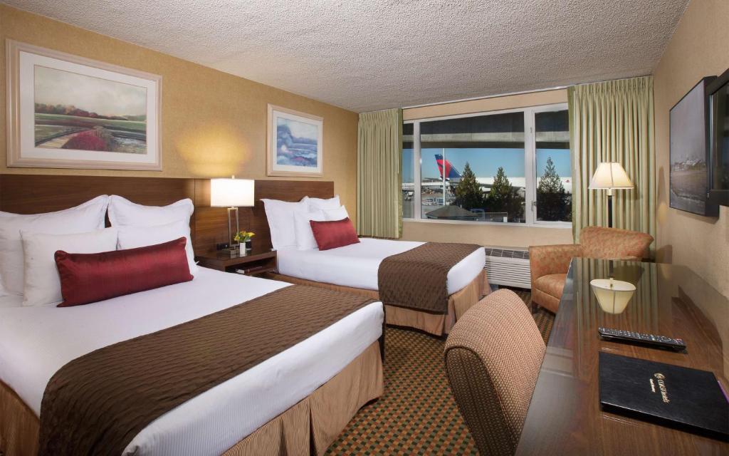 a hotel room with two beds and a window at Coast Gateway Hotel in SeaTac