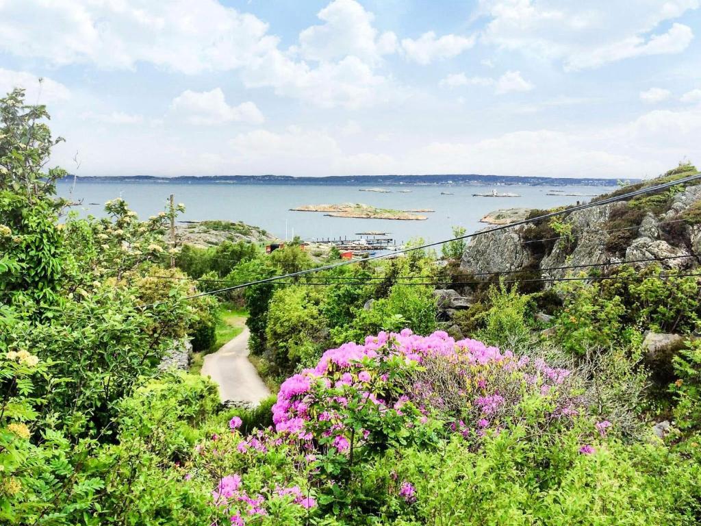 a view of the ocean from a hill with flowers at 4 star holiday home in BRäNNö in Brännö