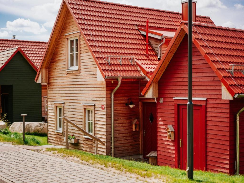a red house with a red roof on a street at Ferienhaus in Schierke for 6 Personen in Schierke