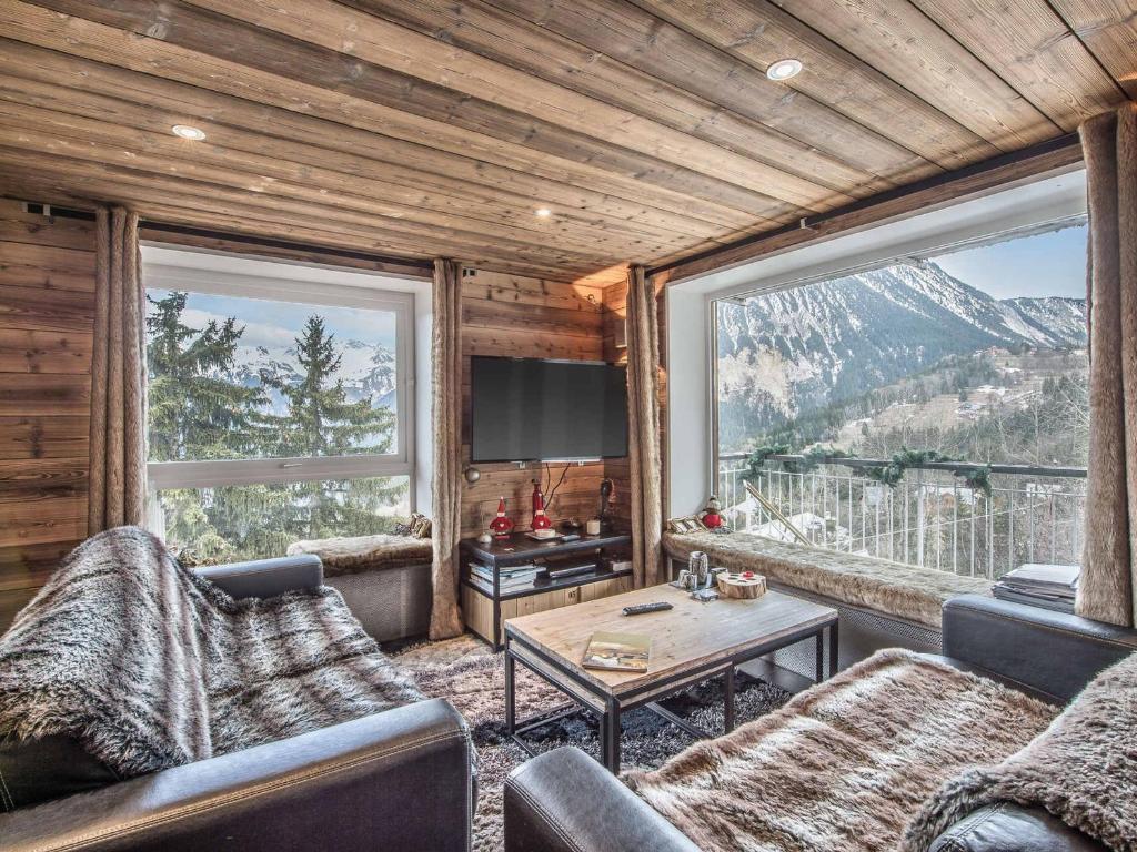a living room with two couches and a table at Chalet Douillet à 200m des Pistes avec Cheminée, Balcon et Baignoire Balnéo - FR-1-562-17 in Courchevel