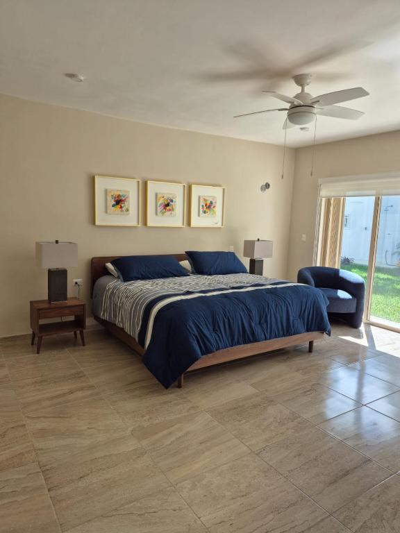 a bedroom with a bed and a ceiling fan at Casa Victoria Cozumel in Cozumel