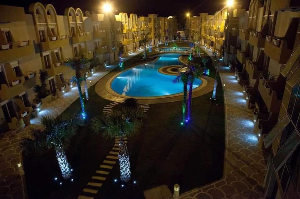 an overhead view of a swimming pool at night at Résidence les dunes in Hammam Sousse