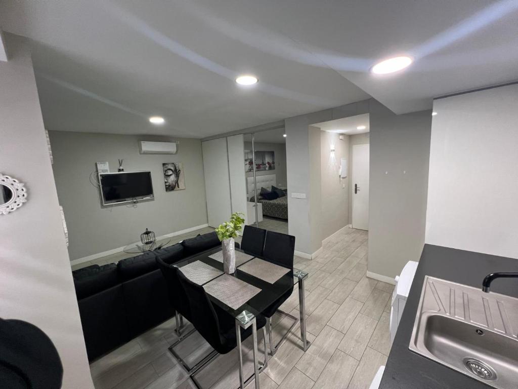 a living room with a couch and a table at El Encanto Andaluz 1 in Córdoba