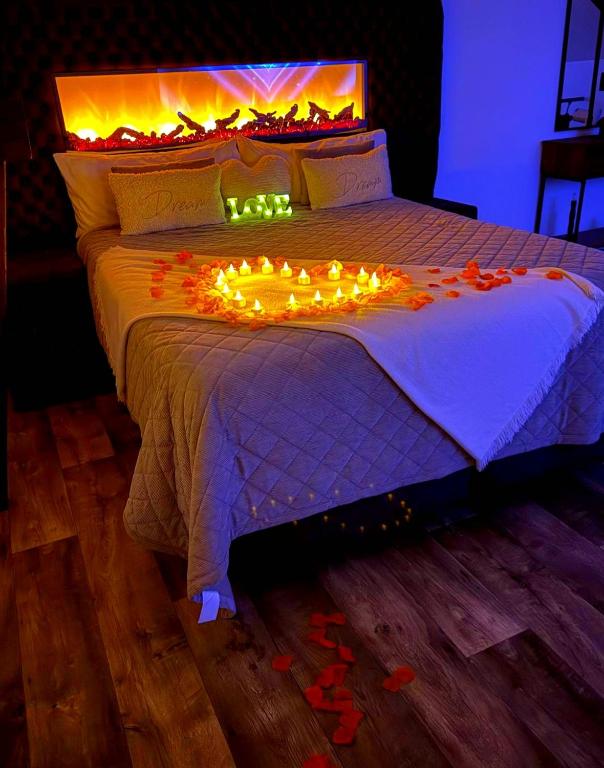 a bed with a bunch of lights on it at Love Room Spa - Sauna - Hammam in Domérat