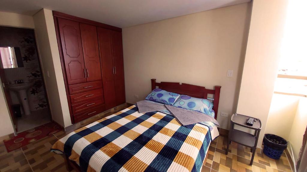 a bedroom with a bed and a wooden door at Edificio K&C in Sogamoso