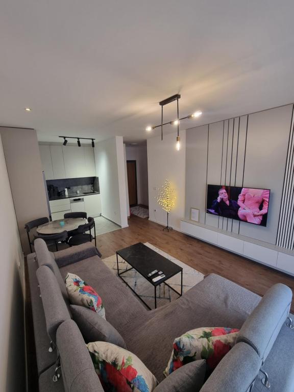 a living room with a couch and a table at M&E Prishtina apartment in Prishtinë