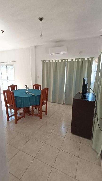 a dining room with a blue table and chairs at Los Pinos de Horizonte in Fernández