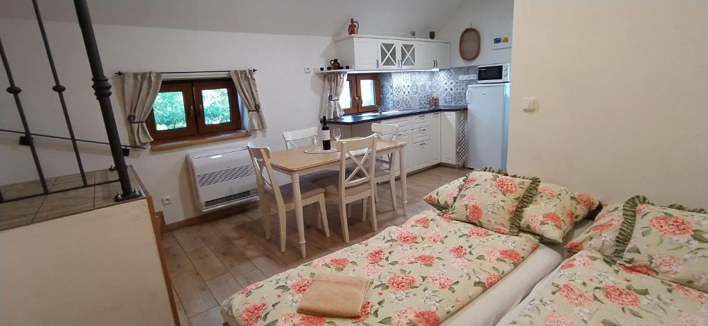 a living room with a couch and a kitchen with a table at Starý dvůr pod Pálavou - Sýpka in Šakvice