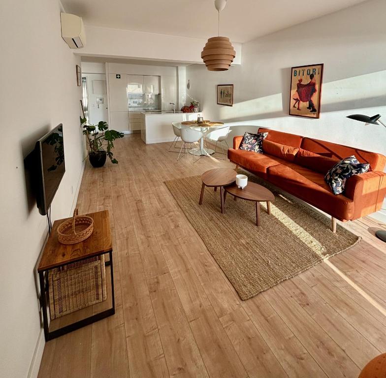a living room with a couch and a table at New Seaview Luxury Apartment - Torre Marimar in Costa da Caparica