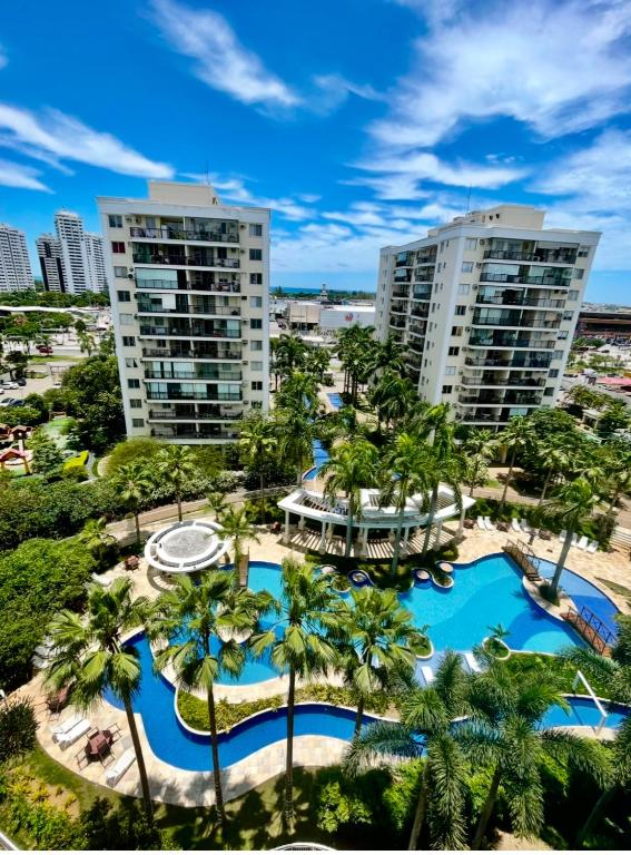 an aerial view of a resort with palm trees at Barra Family Resort com piscina e spa, 2 quartos in Rio de Janeiro