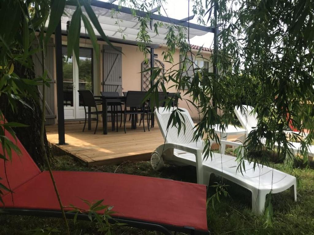 a patio with a white bench and a table at Maison tranquille avec jardin et wifi, 3 chambres - FR-1-336-116 in Avrillé