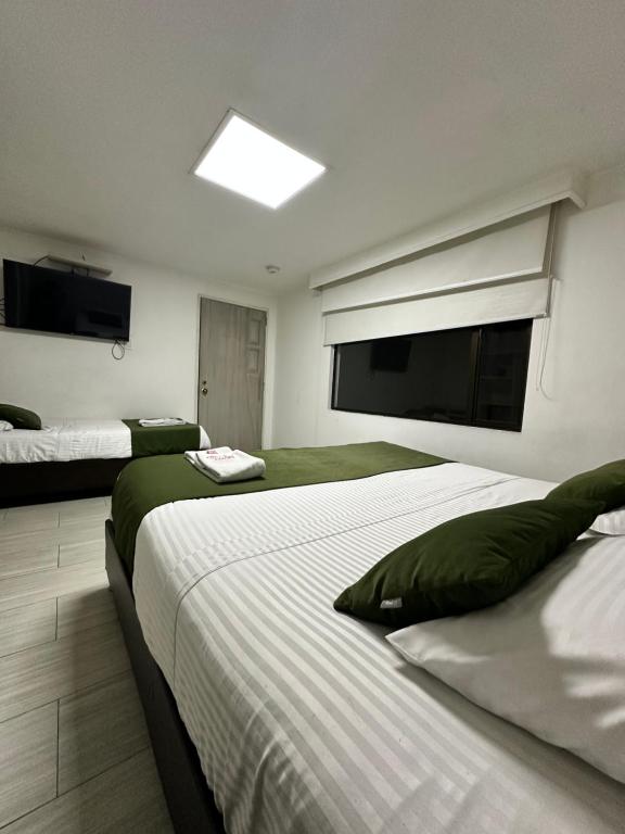 Postel nebo postele na pokoji v ubytování Hotel Bestmark Platino en Chapinero Bogota