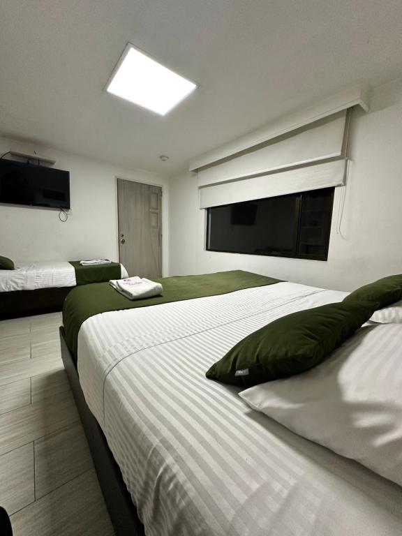 Postel nebo postele na pokoji v ubytování Hotel Bestmark Platino en Chapinero Bogota