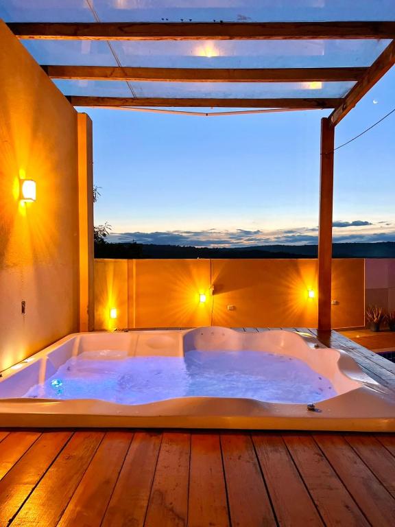 a jacuzzi tub in a room with a view at Casa Diamantina in Ibicoara