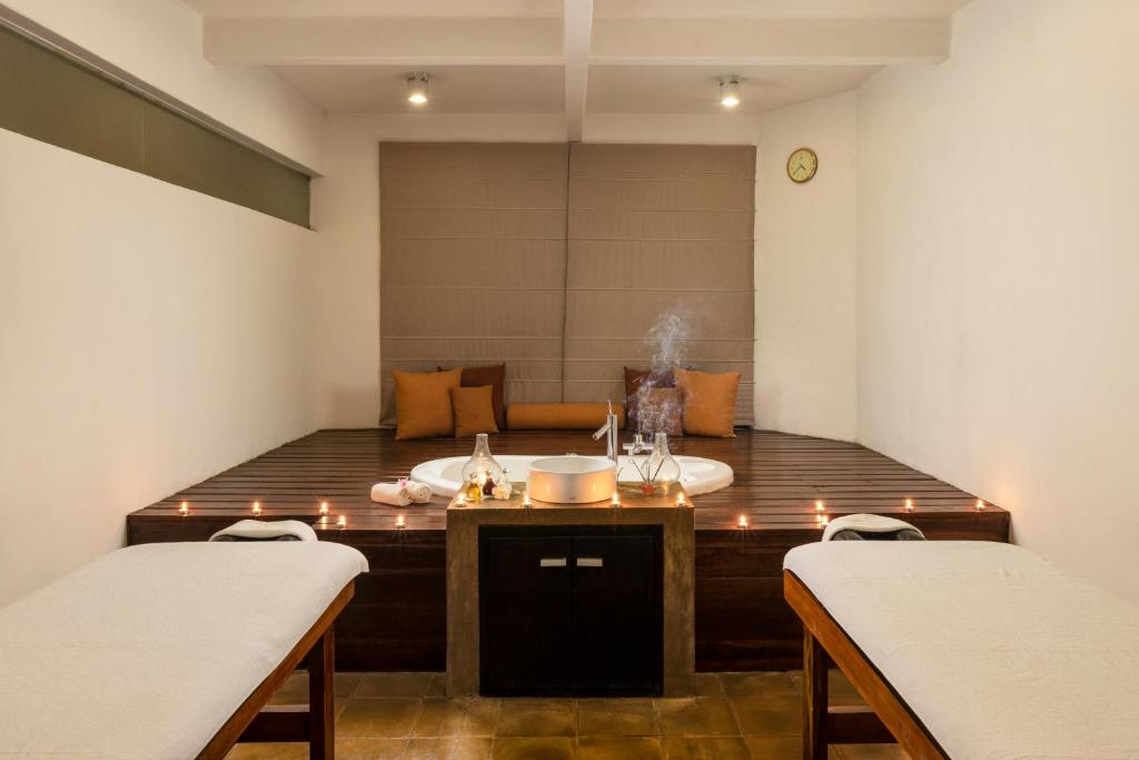 a room with a table with candles on it with two chairs at Jetwing Beach in Negombo