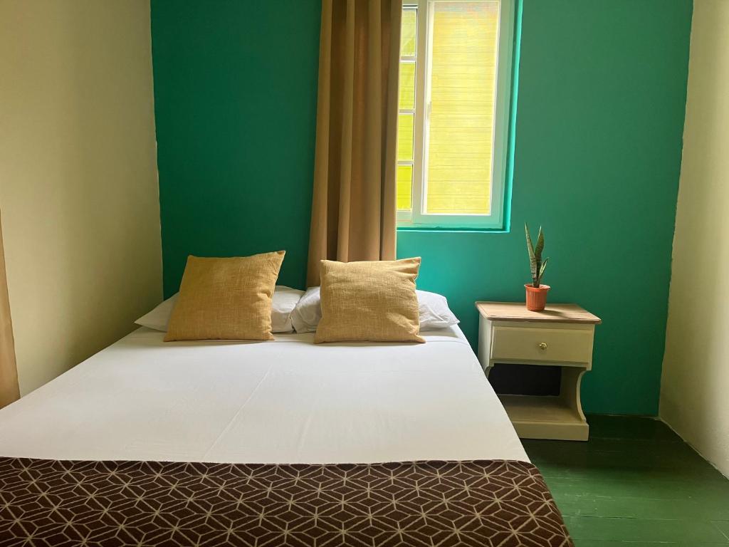 A bed or beds in a room at Hostal Cay