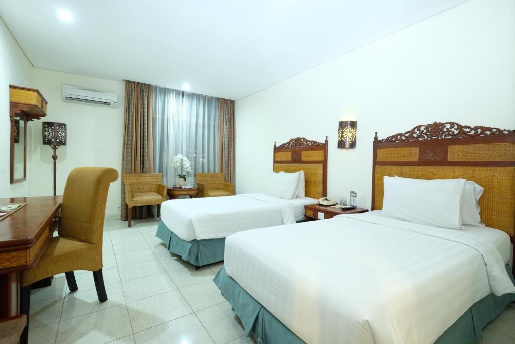 Postel nebo postele na pokoji v ubytování Kusuma Sahid Prince Hotel Solo