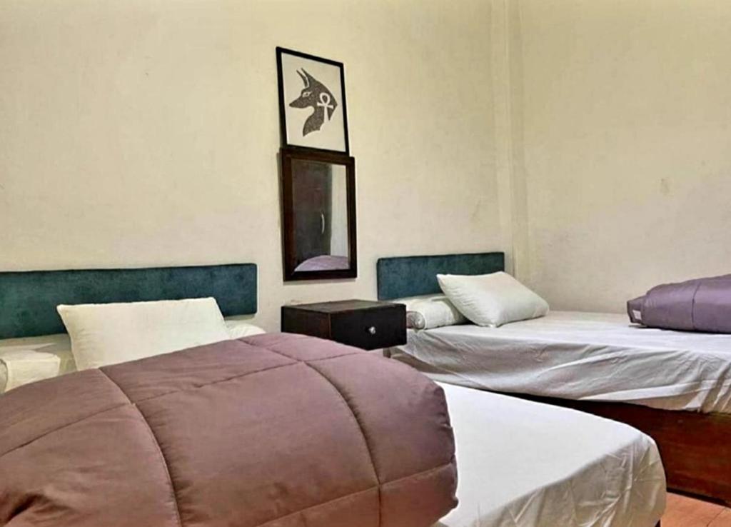 Postel nebo postele na pokoji v ubytování G Hostel inn pyramids