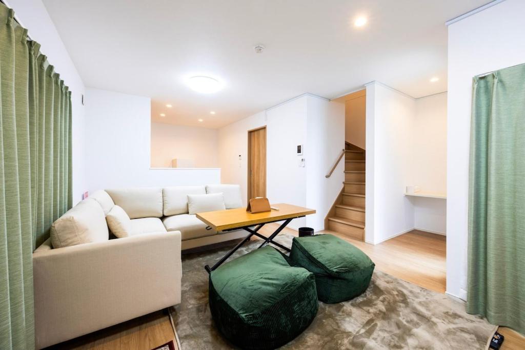 a living room with a couch and a table at Port House Fukuoka in Fukuoka