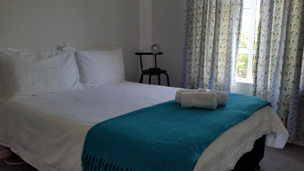a bedroom with a bed with a teddy bear on it at Bradclin at Mutual, Pinelands in Pinelands