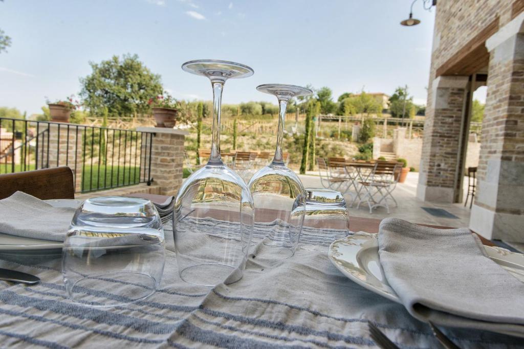 a table with two wine glasses and plates on it at Villa Sant'Angelo in Alba Adriatica