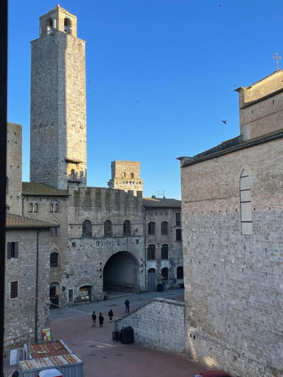 a view of a castle with two towers at Casa dell Erbe in San Gimignano