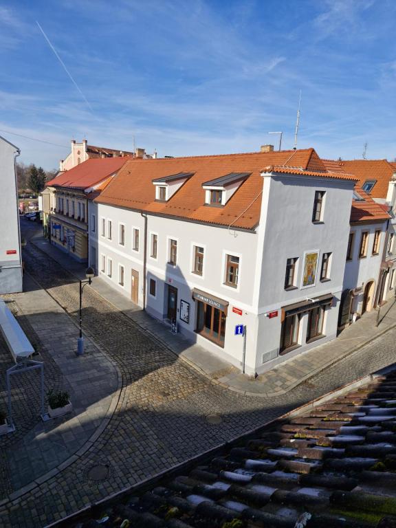 a large white building with a red roof at Pension U Tří sedláků in České Budějovice