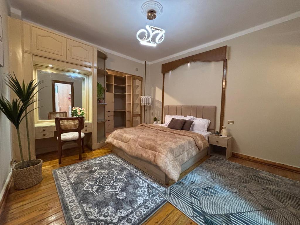 a bedroom with a bed and a table and a chair at Sunset homes in Downtown Cairo in Cairo