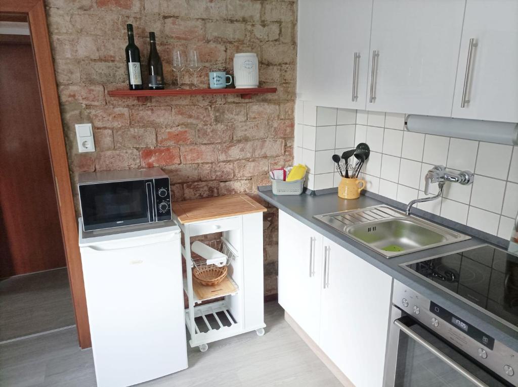 Kuchyň nebo kuchyňský kout v ubytování Poppenga - Feha Wallperle