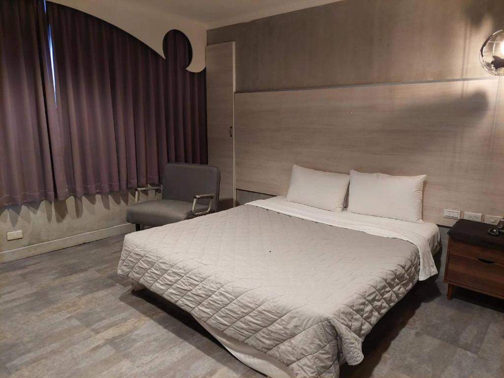 Postel nebo postele na pokoji v ubytování Hwa Nan Hotel