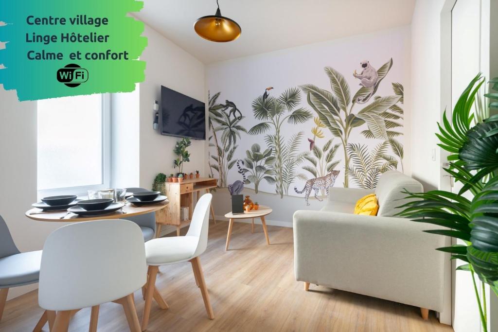 a living room with a couch and a table at THYM * Cosy * Fibre * Confort in La Destrousse