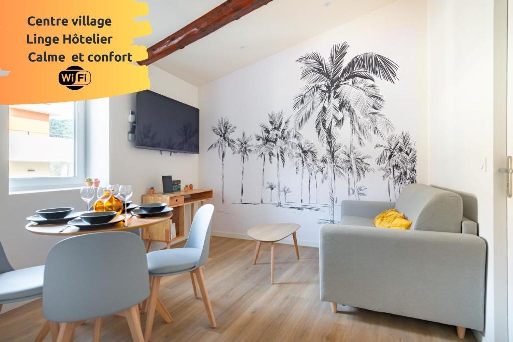 d'une salle à manger avec une table et des chaises ornée d'une fresque murale représentant des palmiers. dans l'établissement Olivier * Cosy * Linge hôtelier * Fibre * Calme, à La Destrousse